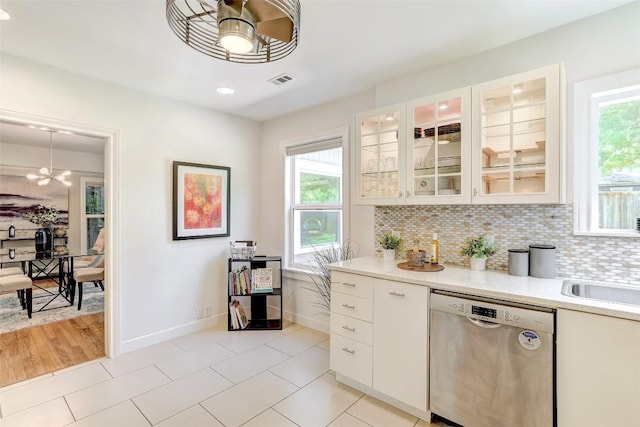 3902 Willbert Rd, Austin, TX 78751 - kitchen with stainless steel dishwasher, light countertops, baseboards, and a chandelier