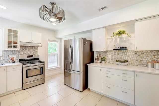3902 Willbert Rd, Austin, TX 78751 - kitchen featuring appliances with stainless steel finishes, open shelves, under cabinet range hood, and backsplash