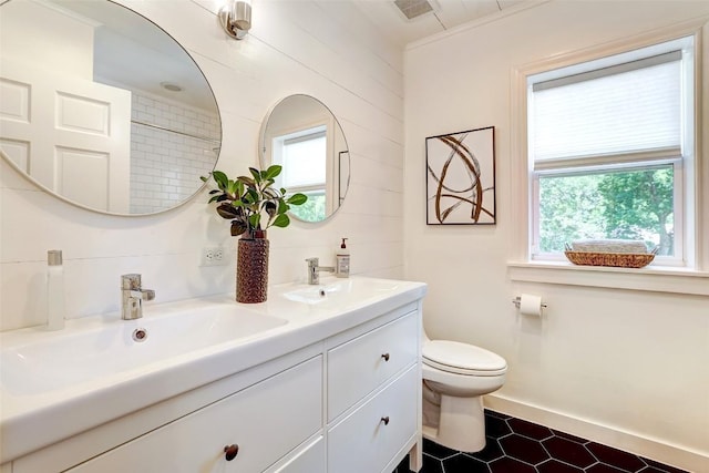 3902 Willbert Rd, Austin, TX 78751 - bathroom featuring double vanity, toilet, and baseboards