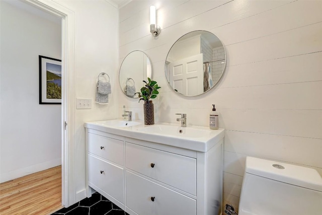 3902 Willbert Rd, Austin, TX 78751 - full bathroom with double vanity, toilet, and baseboards