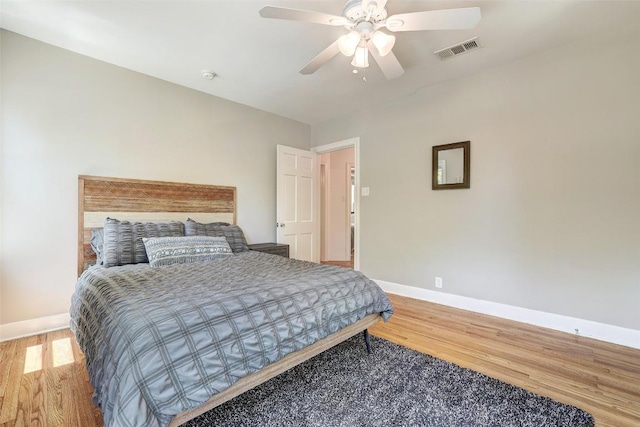 3902 Willbert Rd, Austin, TX 78751 - bedroom with baseboards, wood finished floors, and a ceiling fan