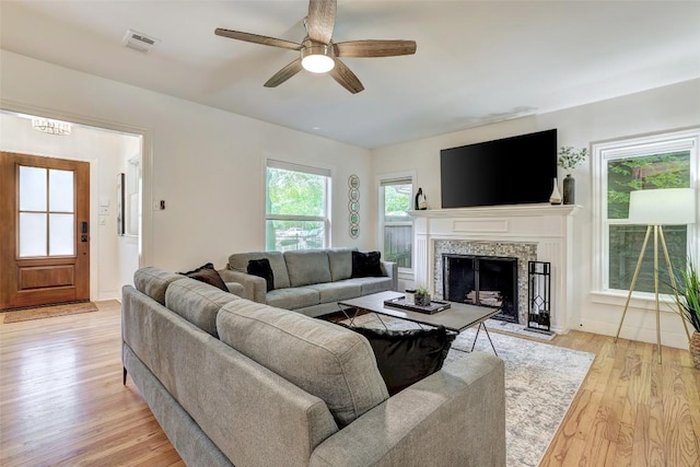 3902 Willbert Rd, Austin, TX 78751 - living room featuring light wood-style floors, ceiling fan, and a high end fireplace