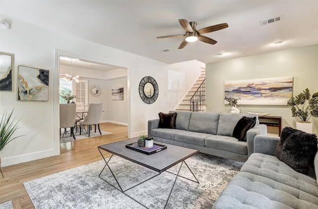3902 Willbert Rd, Austin, TX 78751 - living area featuring wood finished floors, baseboards, stairs, a ceiling fan, and a chandelier