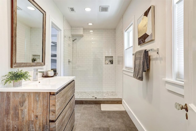 3902 Willbert Rd, Austin, TX 78751 - full bathroom featuring walk in shower, vanity, recessed lighting, tile patterned floors, and baseboards
