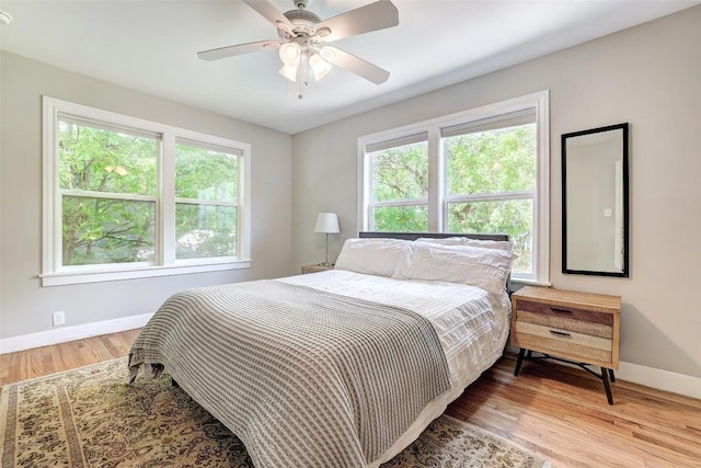 3902 Willbert Rd, Austin, TX 78751 - bedroom with baseboards, multiple windows, light wood finished floors, and a ceiling fan