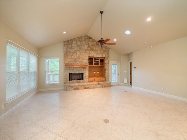 1008 Laurel Oak Cir, Marble Falls, TX 78654 - unfurnished living room with ceiling fan, baseboards, a stone fireplace, light tile patterned floors, and high vaulted ceiling