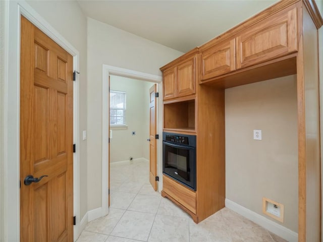1008 Laurel Oak Cir, Marble Falls, TX 78654 - kitchen featuring black oven, baseboards, and light tile patterned floors