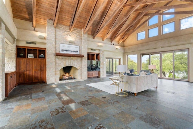 unfurnished living room featuring a fireplace, visible vents, wood ceiling, and beamed ceiling