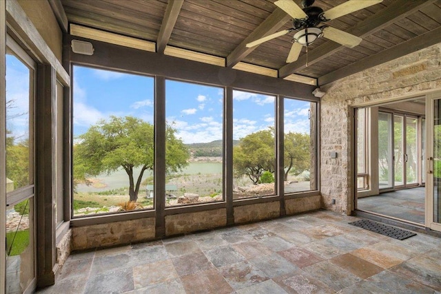unfurnished sunroom featuring wood ceiling, stone tile floors, beamed ceiling, and visible vents