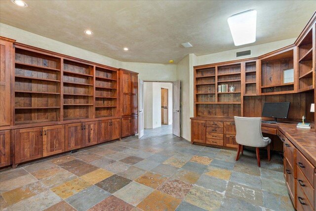 unfurnished office with visible vents, built in study area, recessed lighting, and stone tile flooring