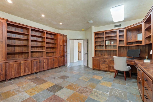 24736 Travis Lakeside Cv, Spicewood, TX 78669 - home office with built in desk, stone tile flooring, and recessed lighting