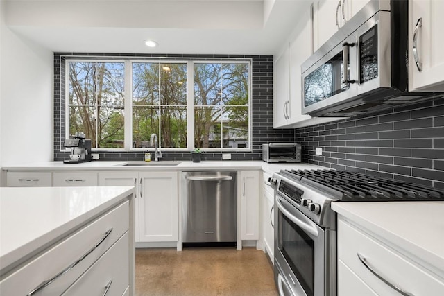 1503 Richcreek Rd Unit A, Austin, TX 78757 - kitchen featuring stainless steel appliances, backsplash, healthy amount of natural light, and recessed lighting