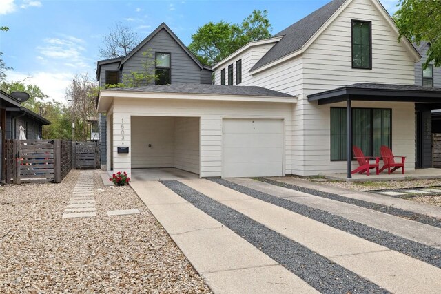 1503 Richcreek Rd Unit A, Austin, TX 78757 - view of front of house with concrete driveway, a garage, and roof with shingles