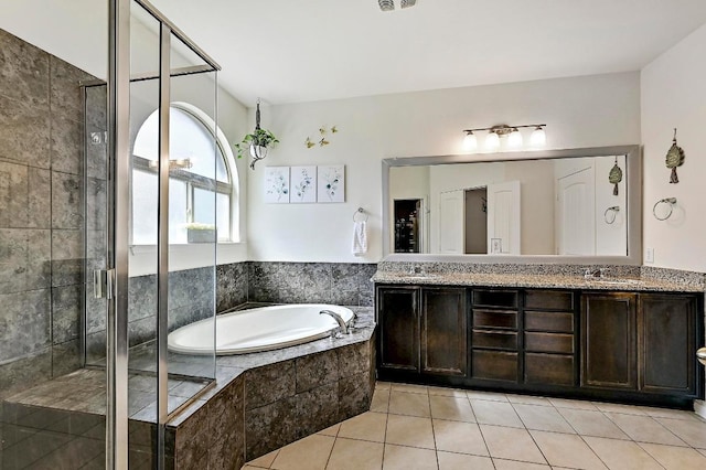 2605 Etta May Ln, Leander, TX 78641 - bathroom with a garden tub, double vanity, a stall shower, and tile patterned floors