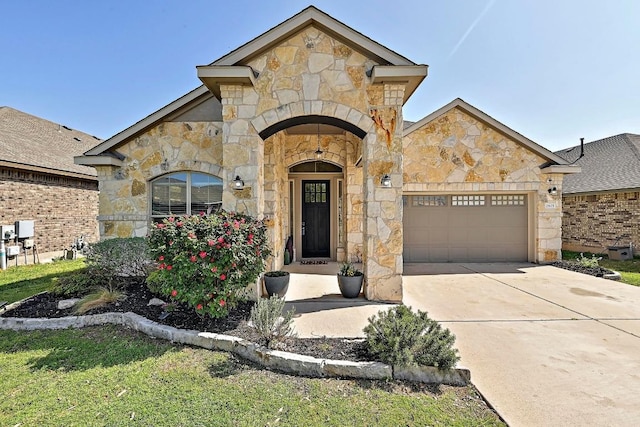 2605 Etta May Ln, Leander, TX 78641 - french country inspired facade featuring stone siding, an attached garage, and driveway