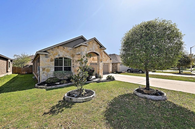 2605 Etta May Ln, Leander, TX 78641 - french country inspired facade featuring stone siding, concrete driveway, and an attached garage