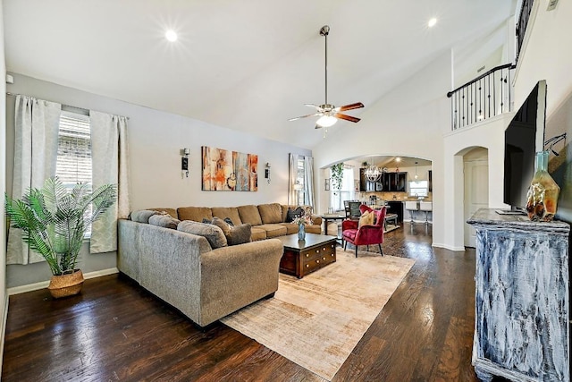 2605 Etta May Ln, Leander, TX 78641 - living area featuring arched walkways, ceiling fan, dark wood-style flooring, vaulted ceiling, and baseboards