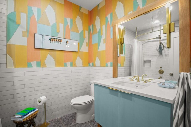 2007 Alameda Dr, Austin, TX 78704 - bathroom with vanity, a shower with curtain, wallpapered walls, tile walls, and wainscoting