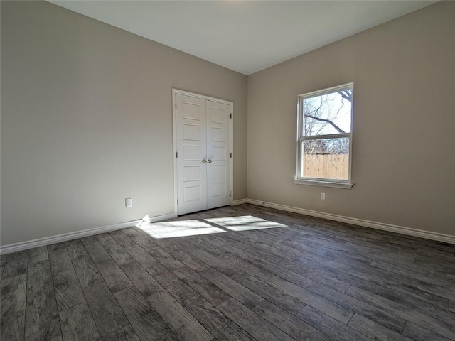 407 Gamel St, Lampasas, TX 76550 - unfurnished bedroom featuring dark wood-type flooring, baseboards, and a closet