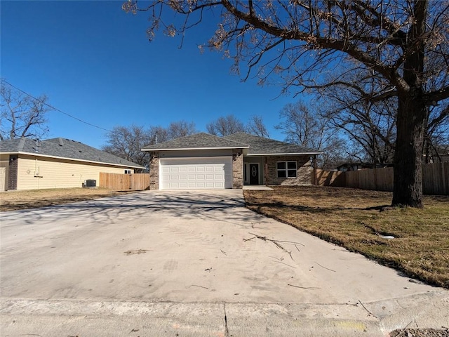 407 Gamel St, Lampasas, TX 76550 - view of front of house featuring an attached garage, concrete driveway, and brick siding