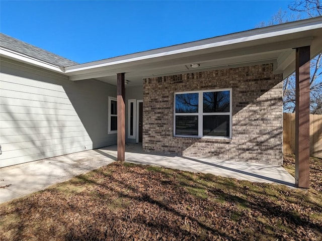 407 Gamel St, Lampasas, TX 76550 - view of exterior entry with brick siding and a patio area