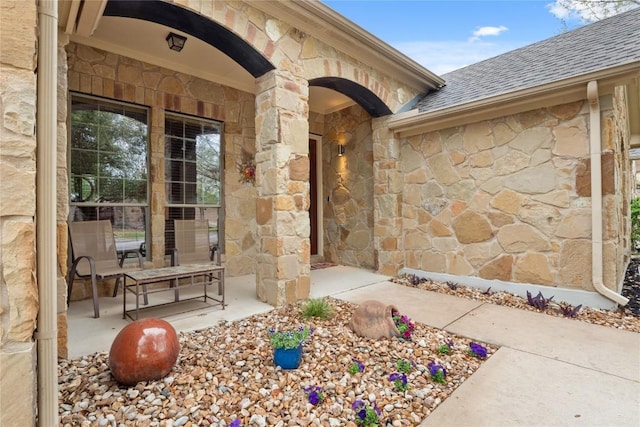 2009 Manada Trl, Cedar Park, TX 78641 - doorway to property featuring stone siding, a shingled roof, and covered porch
