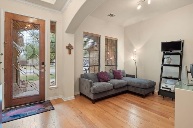 2009 Manada Trl, Cedar Park, TX 78641 - foyer with arched walkways, light wood-style flooring, and ornamental molding