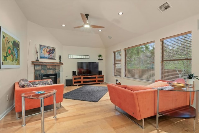 2009 Manada Trl, Cedar Park, TX 78641 - living area featuring ceiling fan, light wood finished floors, a tiled fireplace, vaulted ceiling, and recessed lighting