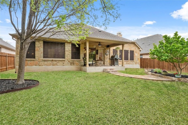 2009 Manada Trl, Cedar Park, TX 78641 - back of property featuring stone siding, a fenced backyard, a ceiling fan, and a chimney