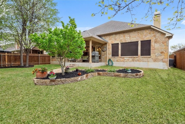 2009 Manada Trl, Cedar Park, TX 78641 - back of house featuring stone siding, a chimney, a patio area, a fenced backyard, and roof with shingles