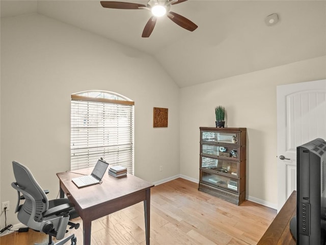 home office with baseboards, lofted ceiling, a ceiling fan, and light wood finished floors