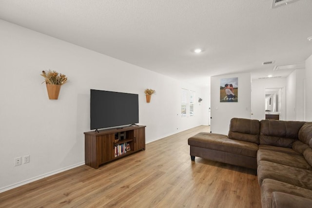 197 Buenos Aires, Kyle, TX 78640 - living room featuring light wood-style floors, baseboards, and recessed lighting