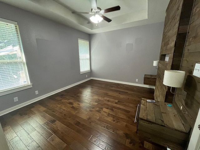 2101 Rivers Edge Way Unit 17, Austin, TX 78741 - empty room featuring hardwood / wood-style flooring, a raised ceiling, a ceiling fan, and baseboards