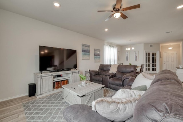 2300 Cliffbrake Way, Georgetown, TX 78626 - living area featuring light wood-type flooring, baseboards, a chandelier, ceiling fan, and recessed lighting