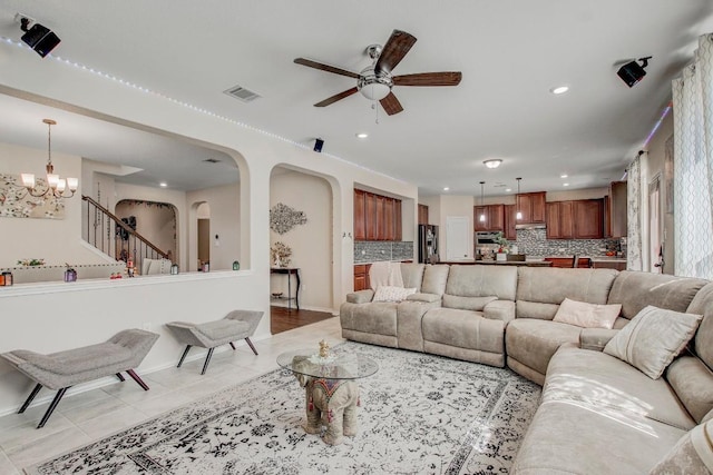285 Kat Garnet Dr, Kyle, TX 78640 - living area featuring a ceiling fan, light tile patterned floors, arched walkways, recessed lighting, and a chandelier