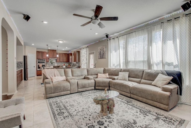 285 Kat Garnet Dr, Kyle, TX 78640 - living area featuring recessed lighting, a ceiling fan, light tile patterned flooring, and arched walkways