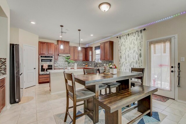 285 Kat Garnet Dr, Kyle, TX 78640 - dining room featuring light tile patterned floors and recessed lighting