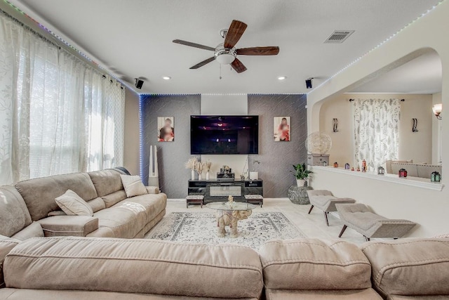 285 Kat Garnet Dr, Kyle, TX 78640 - living room featuring arched walkways, ceiling fan, and recessed lighting