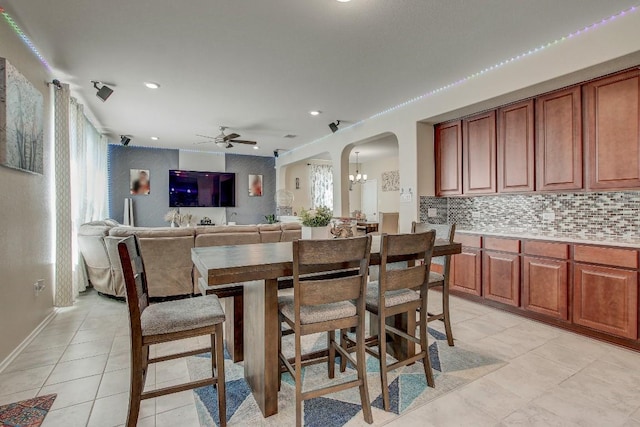285 Kat Garnet Dr, Kyle, TX 78640 - dining space featuring arched walkways, a ceiling fan, light tile patterned floors, recessed lighting, and a chandelier
