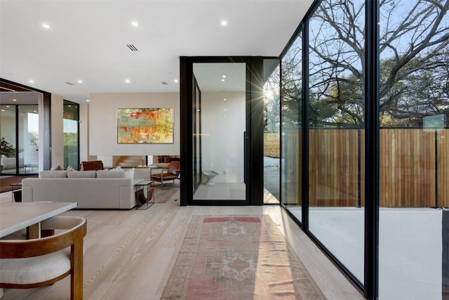 2605 Rockingham Dr, Austin, TX 78704 - doorway with light wood-style floors, expansive windows, and recessed lighting