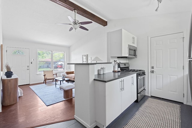306 Tilbury Ln, Austin, TX 78745 - kitchen featuring stainless steel appliances, ceiling fan, dark wood finished floors, dark countertops, and white cabinets