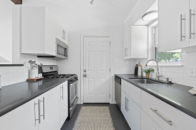 306 Tilbury Ln, Austin, TX 78745 - kitchen featuring stainless steel appliances, white cabinetry, and dark countertops