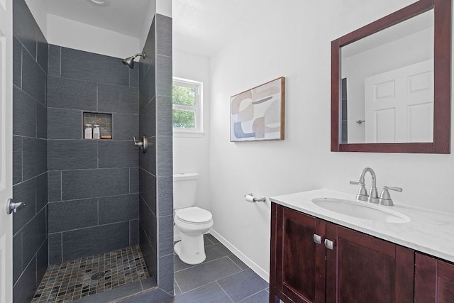 306 Tilbury Ln, Austin, TX 78745 - full bathroom featuring vanity, a tile shower, and tile patterned flooring