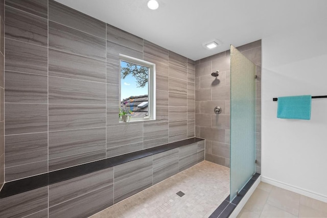 full bath with tile patterned floors, a walk in shower, and baseboards