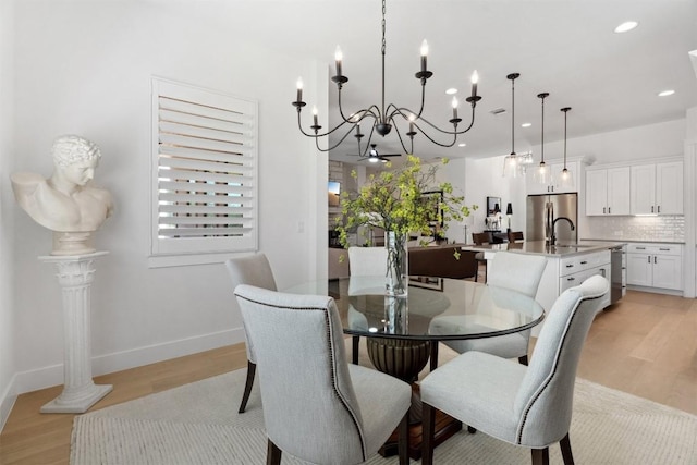 744 Buffalo Trl, Liberty Hill, TX 78642 - dining area featuring a chandelier, light wood-style flooring, and recessed lighting