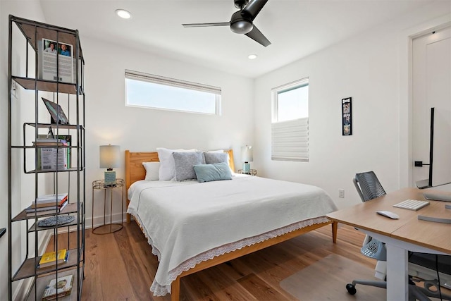 bedroom with wood finished floors and recessed lighting