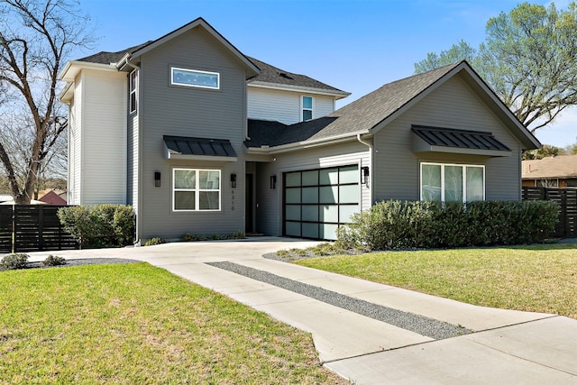 view of front of home featuring fence, concrete driveway, roof with shingles, a front yard, and a garage
