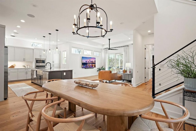 dining space featuring stairway, light wood-style floors, and recessed lighting
