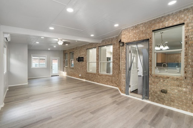 8613 Columbia Falls Dr, Round Rock, TX 78681 - spare room featuring brick wall, wood finished floors, ceiling fan, recessed lighting, and an AC wall unit