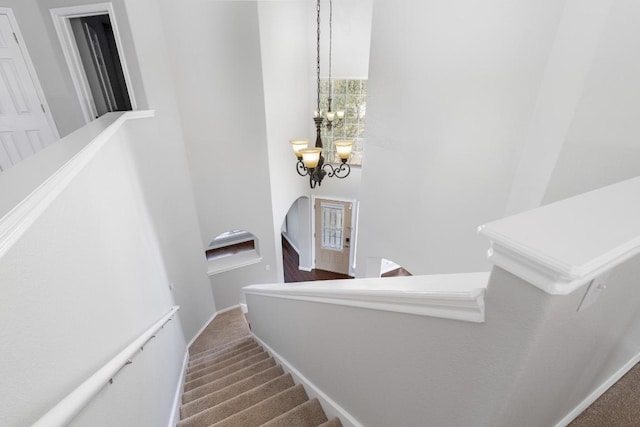 8613 Columbia Falls Dr, Round Rock, TX 78681 - stairway featuring arched walkways, a chandelier, and carpet flooring